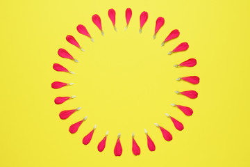 Circle of red floral petals on yellow background
