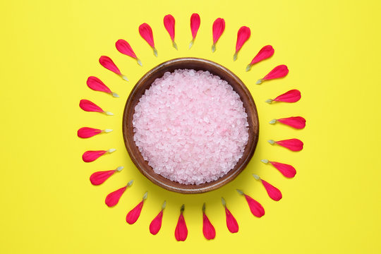 Pink Sea Salt In Bowl For Spa And Bath On Yellow Background With Petals