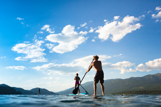 People stand up paddleboarding, Whitefish Lake, Whitefish, Glacier Country, Montana, USA.