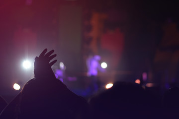 silhouettes of  , Fun concert party rock disco light background.