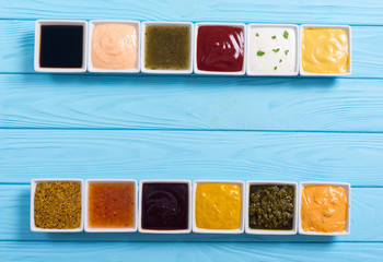 Set of different sauces in ceramic bowl