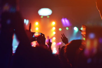 silhouettes of  , Fun concert party rock disco light background.