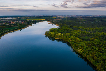 Fototapeta na wymiar Aerial drone photography of a lake landscape during sunset. Beautiful and calm rural landscape. 