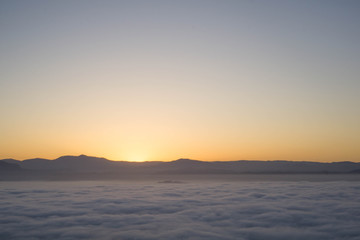 start of sunrise in the mountains and sea of clouds