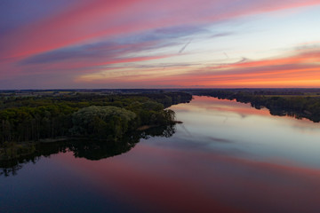Aerial drone photography of a lake landscape during sunset. Beautiful and calm rural landscape. 