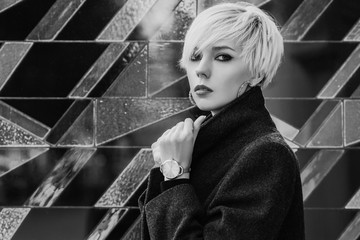 Close up monochrome, black and white fashion portrait of young beautiful woman with short blonde...