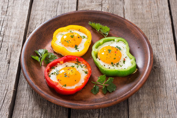 Yellow , red and green pepper with fried eggs
