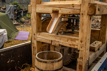 Fototapeta na wymiar small hand made wooden mill for grain for bread in European village country side place 