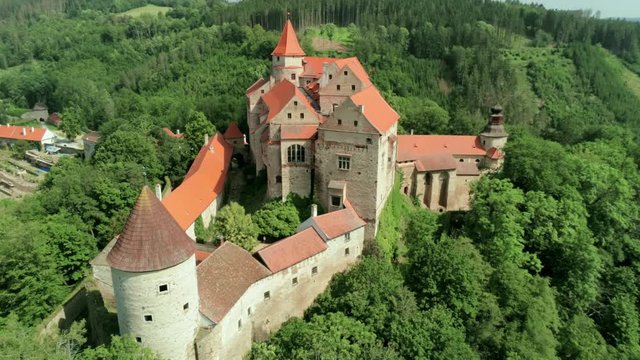 Aerial View of Fabulous Pernstejn Castle (hrad Pernstejn) on a rock in the South Moravian Region, Czech Republic, Europe. 4K Drone Tilt shot