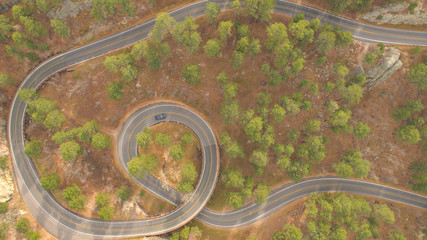 AERIAL: Scenic pigtail bridge drive on Iron Mountain Road steep windy highway
