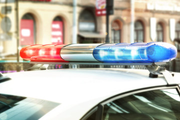 Red and blue signal lights on the roof of a traffic police patrol car © Галина Сандалова