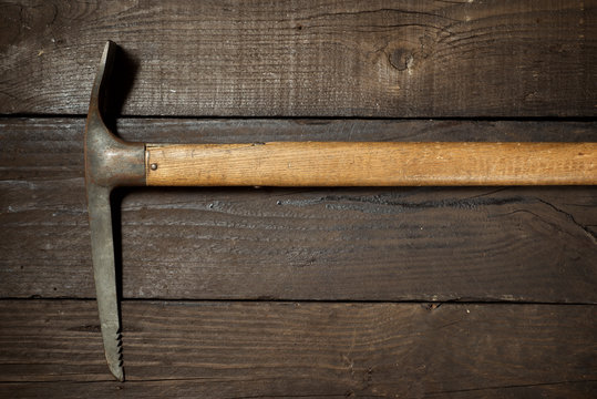Old ice-axe on a wood table