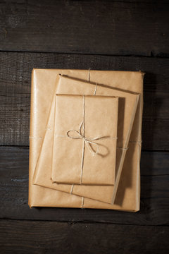 Books wrapped with paper on a wooden table.