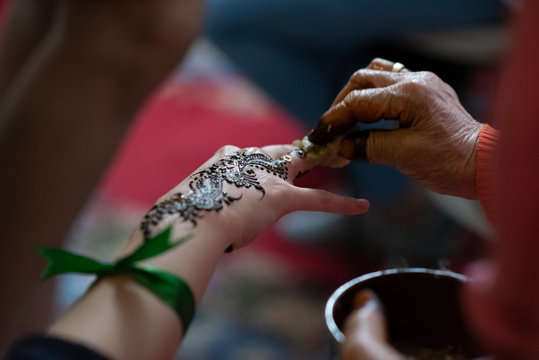 Close up of painted hand woman with henna in a party in Morocco.