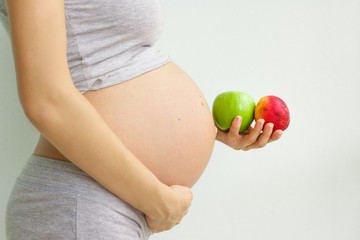 pregnant woman with fruit in her hands. Vitamins for pregnant women. Vegetarianism. Useful products for pregnant women. Diet during pregnancy.
