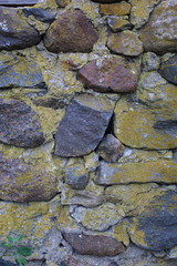 texture of stone wall covered with moss.