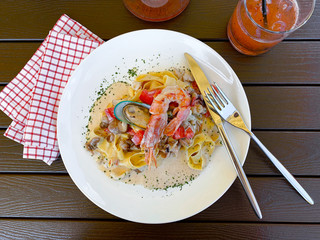 Fettuccine pasta with shrimp, tomatoes and herbs. Top view. Flat lay