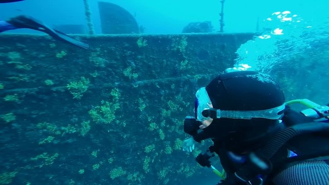Diver Exploring A Large Shipwreck