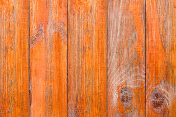 Naklejka premium Old wooden boards with peeling paint. Wooden fence. Grunge style. Orange paint.
