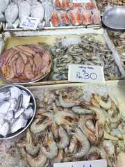 Various types of fish in the fish market are displayed for sale. Labelled with fish species and...