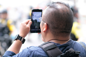 Protestor filming the event on his cellphone.