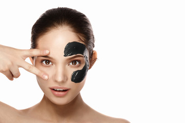 young woman applying moisturizing cream on her face. Skin care concept