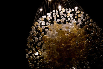 Abstract shot of a chandelier made up of smaller globes illuminated from above