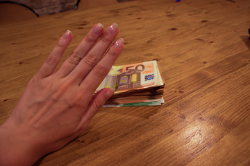 A female caucasian hand refusing and denying a bribe