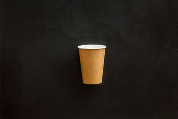 Paper cups for coffee to go on black background top view mockup