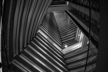Black-and-white shot of the inside of a skyscraper and the pattern the levels create