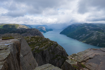 Preikestolen massive cliff (Norway, Lysefjorden summer morning view). Beautiful natural vacation hiking walking travel to nature destinations concept. July 2019