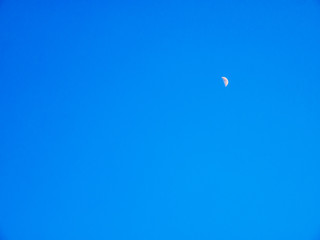 Crescent moon on clean blue sky