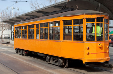 Fototapeta na wymiar San Francisco's vintage F-Line streetcar traveling on the Embarcadero.