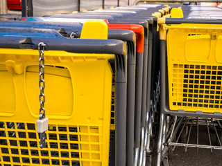 Row of yellow and one red shopping carts at the supermarket