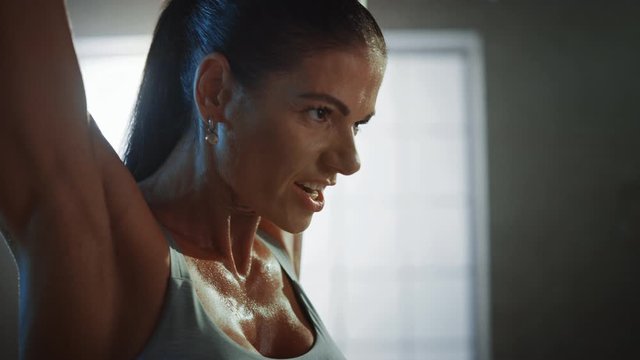 Athletic Beautiful Woman Does Overhead Lift with a Barbell in the Gym. Gorgeous Female Professional Bodybuilder Does Weight Lift Workout Exercises in the Hardcore Training Facility. Zoom in