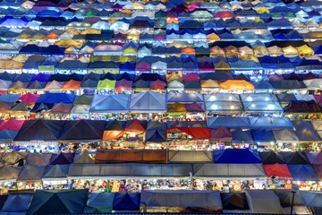 Fototapeta premium Market with colorful tents in sunset time. This is place in Thailand call Train Market