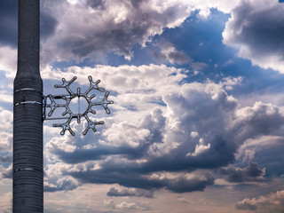 Christmas decoration on street lamp against a gorgeous winter blue sky with clouds