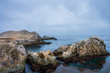 Fototapeta na wymiar Rocks in the Pacific ocean off the coast of Point Lobos State Natural Reserve.