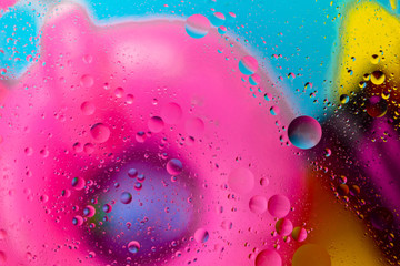 Micro molecular abstract pattern of colored oil bubbles on water. 