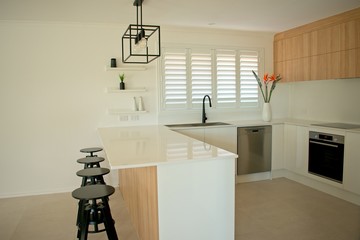Designer kitchen with cabinets and stainless steel appliances.