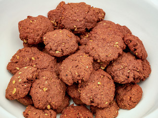 Chocolate homemade cookies with nuts, on a pile in a bowl