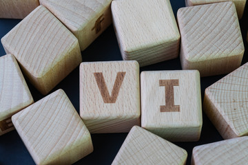 VI, Value investing, investment strategy to picking stocks concept, cube wooden block with alphabet combine the word VI on black chalkboard background