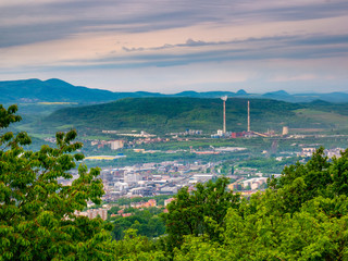 The green valley with the marginal part of the city, slightly covered by the smog of heavy industry