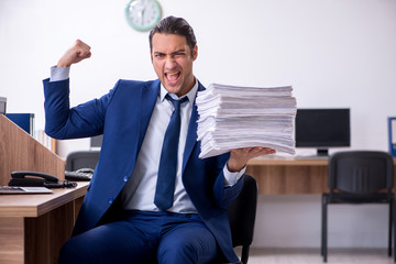 Young handsome businessman working in the office