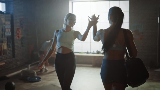 Following Shot of the Beautiful Athletic WomanWalking into Hardcore Gym, Greets Her Friends and Fellow Athletes. Ready for Her Power Workout, Strength Exercise and Bodybuilding Training Session