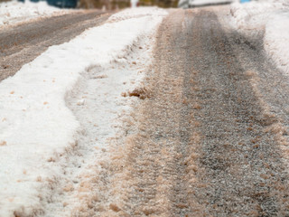 Tire tracks in the snow on the road - selective focus