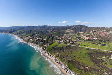 Aerial view of shoreline homes coastal mountains near Los Angeles and Santa Monica in Malibu, California.  