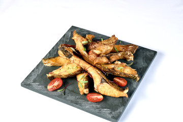 fried fish strips served on stone