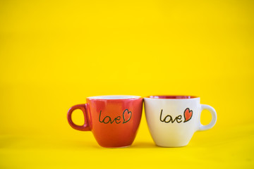 The glass with the words "Love" is put together on a yellow background.