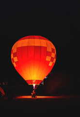The team is preparing a balloon with a fire to make the balloon rise.